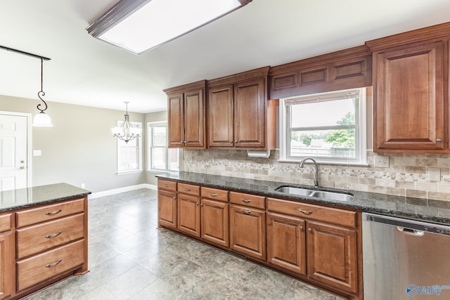 kitchen featuring stainless steel dishwasher, sink, tasteful backsplash, and light tile patterned floors