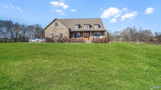 new england style home with covered porch and a front lawn