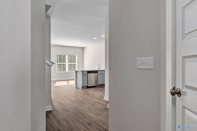 hallway featuring wood-type flooring and sink