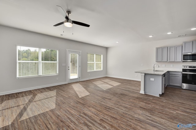 kitchen with sink, gray cabinets, plenty of natural light, and appliances with stainless steel finishes