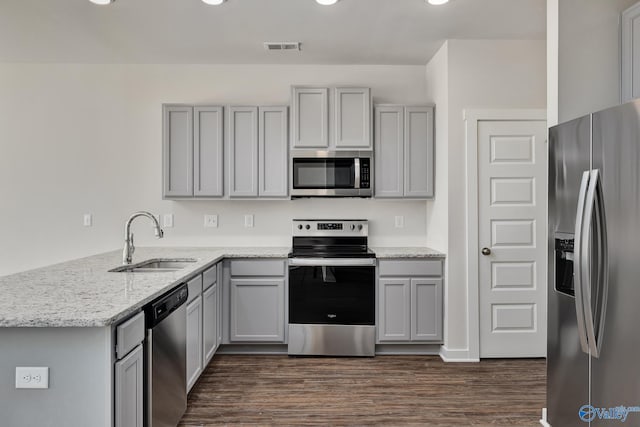 kitchen with gray cabinetry, sink, and appliances with stainless steel finishes