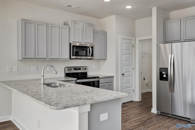 kitchen with gray cabinetry, sink, kitchen peninsula, and appliances with stainless steel finishes