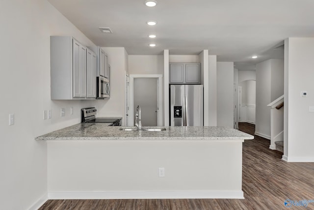 kitchen featuring gray cabinets, sink, light stone counters, kitchen peninsula, and stainless steel appliances