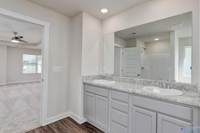 bathroom featuring hardwood / wood-style flooring, vanity, a shower, and ceiling fan