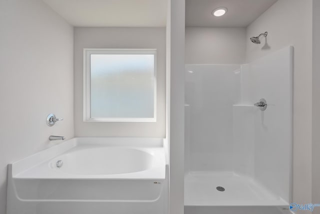 bathroom featuring separate shower and tub