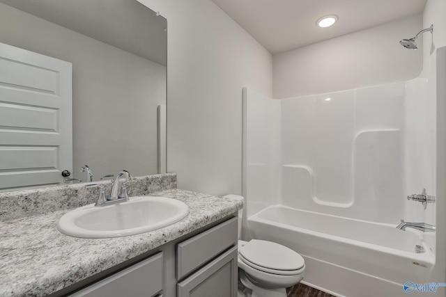 full bathroom with vanity, toilet, and washtub / shower combination