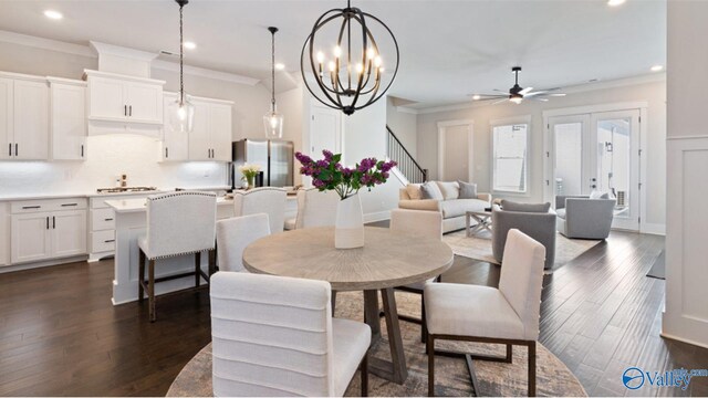 dining area featuring ceiling fan with notable chandelier, dark hardwood / wood-style flooring, and crown molding