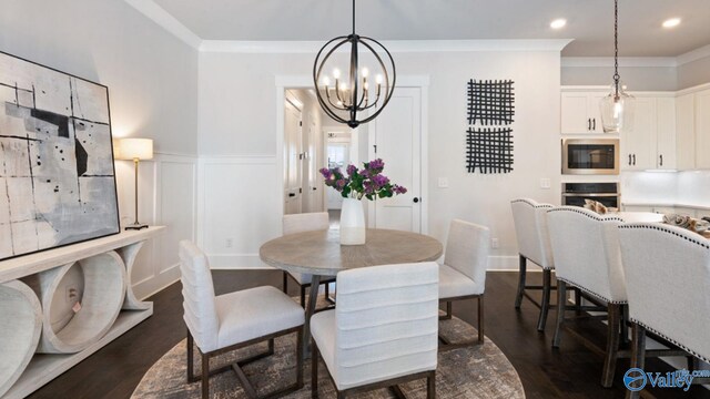 dining area with ornamental molding, dark wood-type flooring, and a notable chandelier