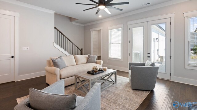 living room with ornamental molding, ceiling fan, dark hardwood / wood-style floors, and french doors