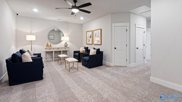 carpeted living room with ceiling fan