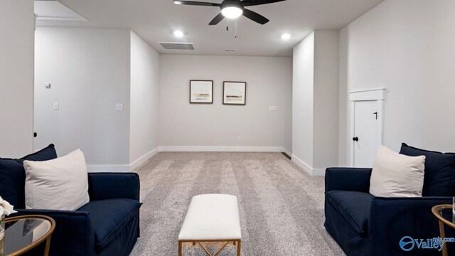 living area with ceiling fan and carpet floors