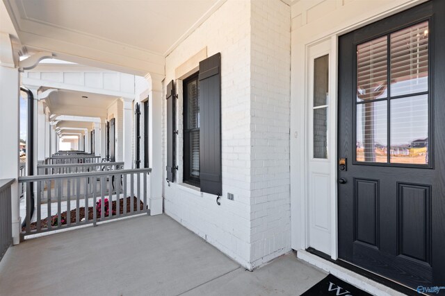 view of exterior entry featuring a porch