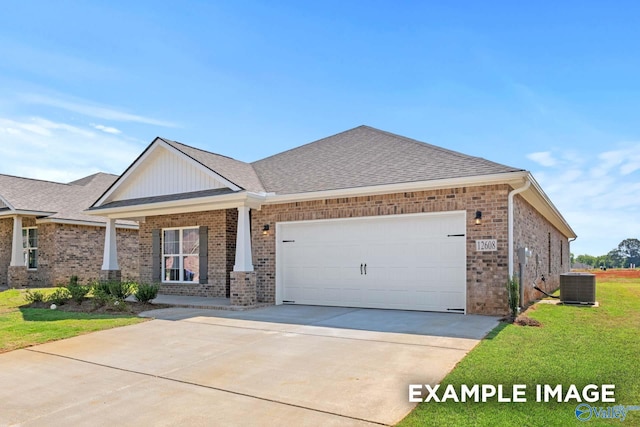 craftsman-style house with central air condition unit, a garage, and a front lawn