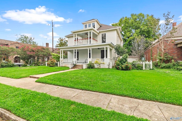 view of front of property featuring a front lawn, a balcony, and a porch