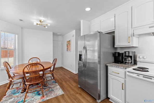 kitchen with visible vents, extractor fan, electric stove, stainless steel refrigerator with ice dispenser, and white cabinetry