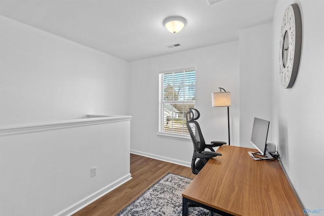 office space featuring visible vents, wood finished floors, and baseboards