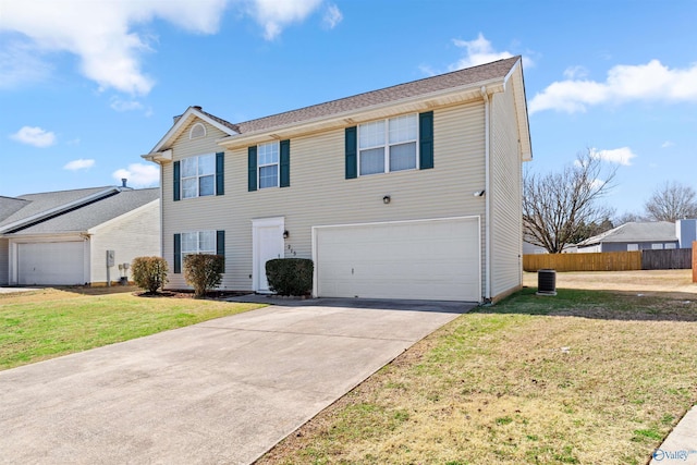 view of front of home featuring a front yard, an attached garage, fence, and driveway