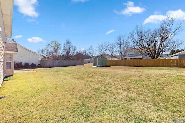 view of yard featuring an outbuilding, fence private yard, and a shed