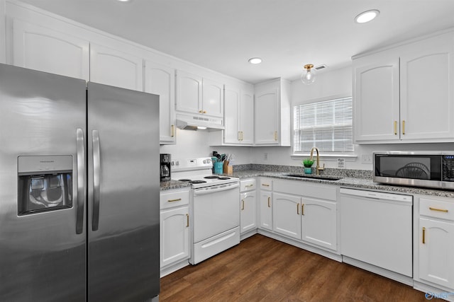 kitchen with a sink, under cabinet range hood, appliances with stainless steel finishes, white cabinetry, and dark wood-style flooring