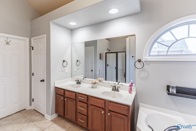 bathroom with tile patterned floors, separate shower and tub, and vanity