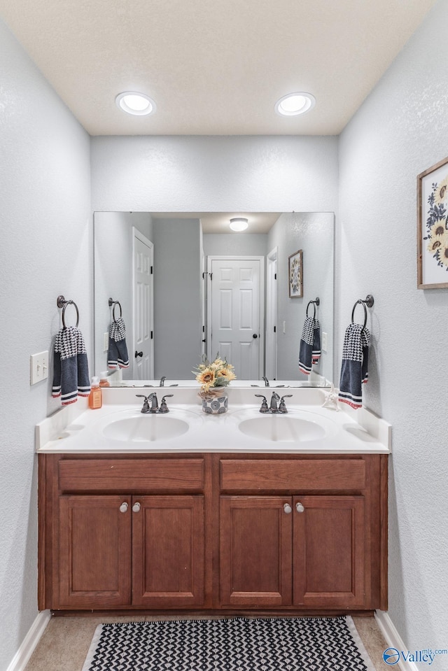 bathroom with tile patterned flooring and vanity