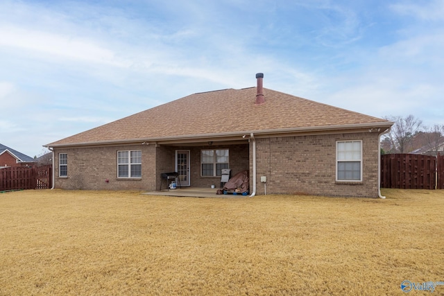 back of property with a patio and a lawn