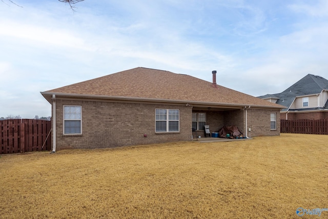 back of property featuring a lawn