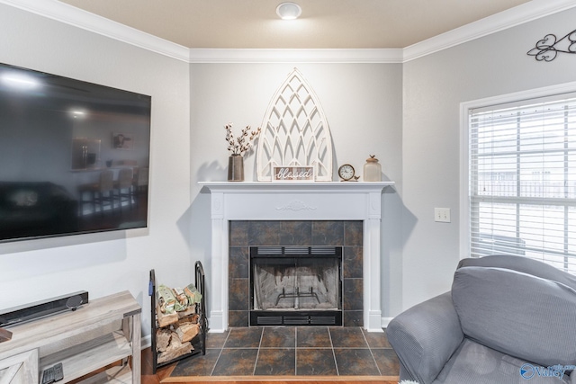 living room featuring a tile fireplace and ornamental molding