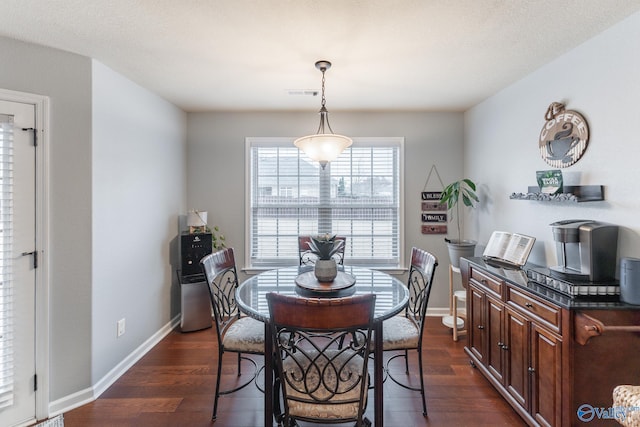 dining room with dark wood-type flooring