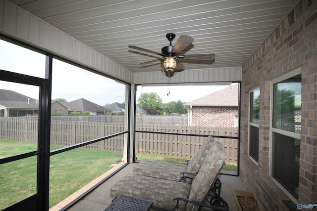sunroom featuring ceiling fan
