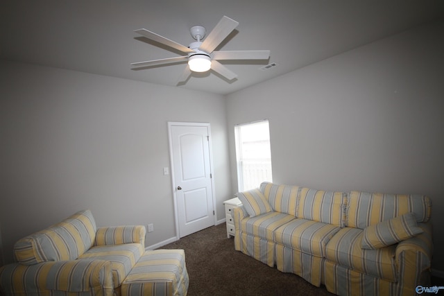 living area with baseboards, a ceiling fan, dark carpet, and visible vents
