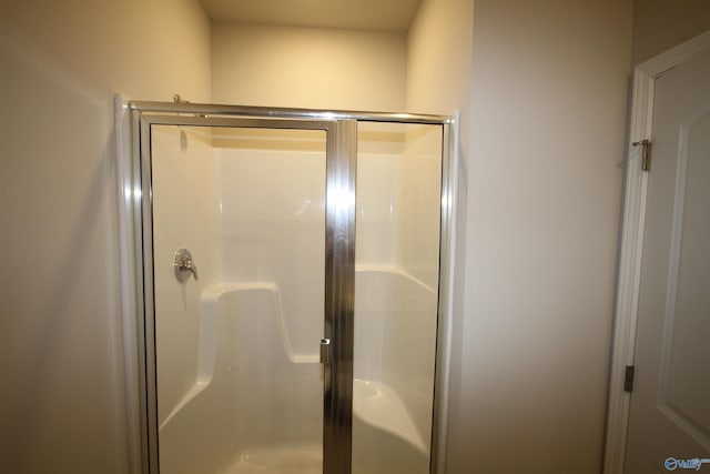 full bath featuring a shower stall