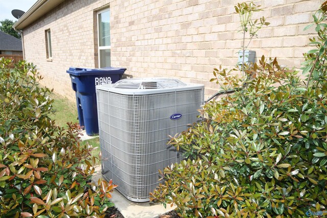 exterior details with brick siding and cooling unit