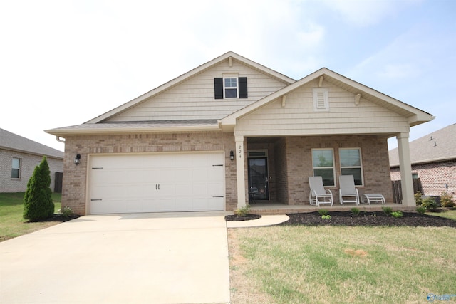 craftsman inspired home featuring a garage, a front lawn, covered porch, brick siding, and driveway