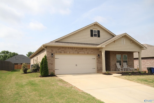 craftsman inspired home with covered porch, a front yard, a garage, brick siding, and concrete driveway