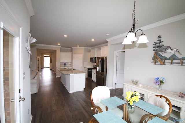 dining room with crown molding, recessed lighting, an inviting chandelier, and dark wood-type flooring