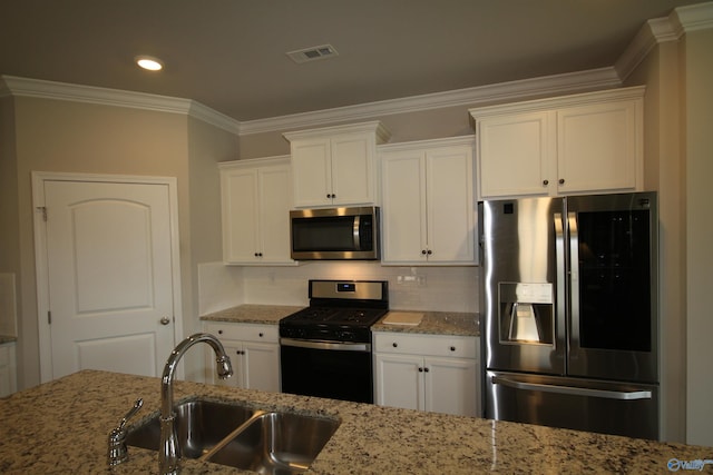 kitchen featuring stainless steel appliances, visible vents, white cabinetry, and a sink
