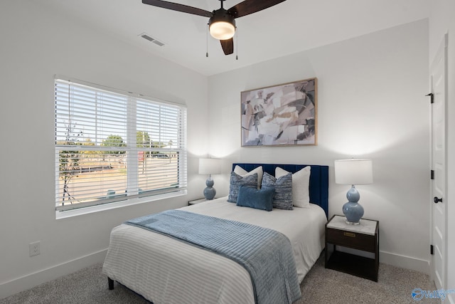 bedroom featuring a ceiling fan, carpet, visible vents, and baseboards