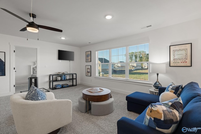 carpeted living area featuring baseboards, visible vents, a ceiling fan, and recessed lighting