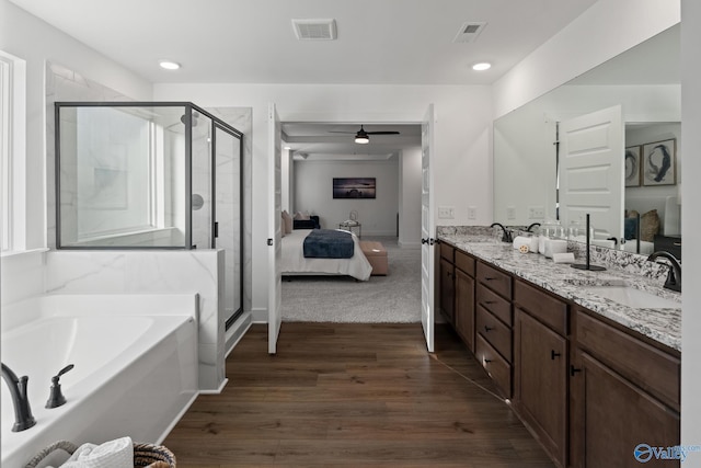 bathroom with connected bathroom, visible vents, a sink, and a bath