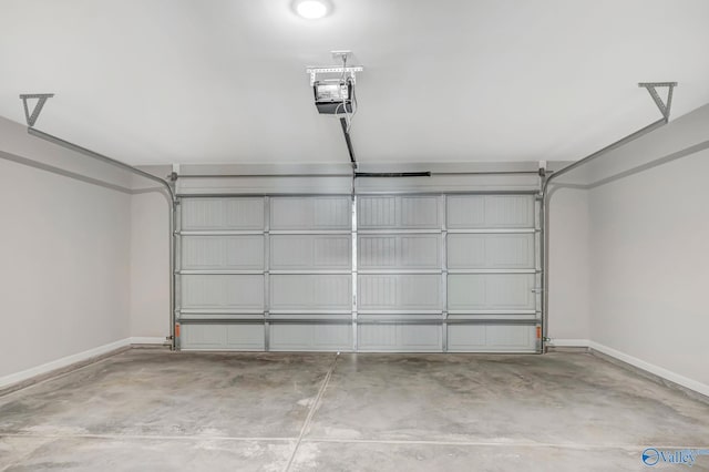 garage featuring a garage door opener and baseboards