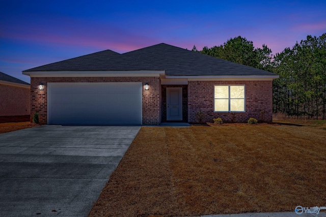 ranch-style home with a front lawn, an attached garage, brick siding, and driveway