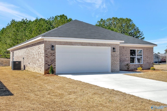 single story home featuring a front lawn, an attached garage, brick siding, and driveway