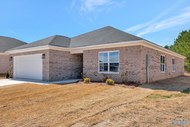 ranch-style house featuring brick siding, a shingled roof, a front yard, driveway, and an attached garage