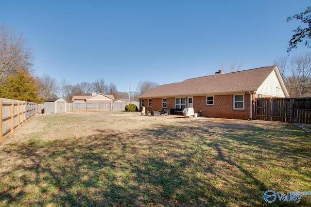 view of yard with a shed and a patio