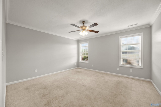 spare room with ornamental molding, light carpet, and ceiling fan