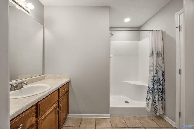 bathroom featuring a shower with curtain, a textured ceiling, vanity, and tile patterned floors