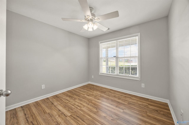 spare room with wood-type flooring and ceiling fan