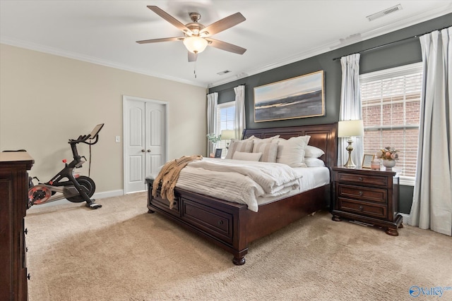 bedroom featuring light carpet, ornamental molding, a closet, and ceiling fan