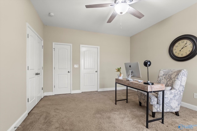 carpeted home office featuring ceiling fan